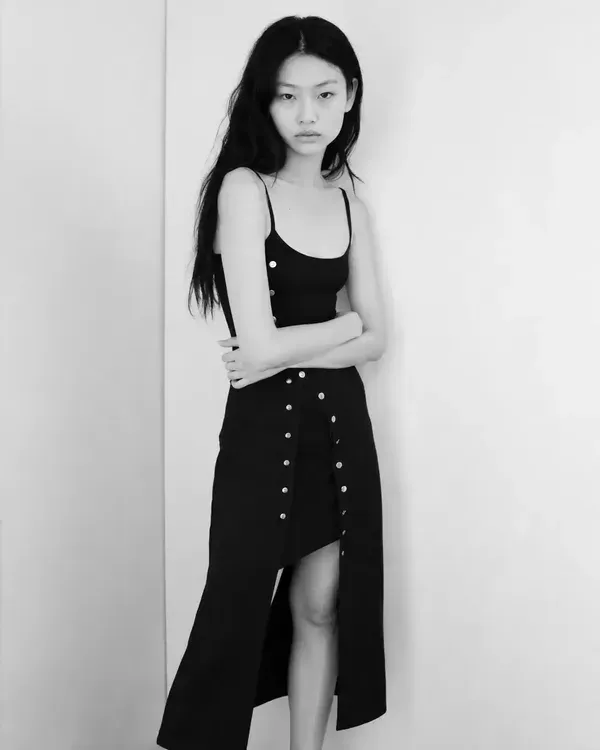 Three black and white photos of a model in a black dress (full length, close-up and half length), like the photos an agency asks to see