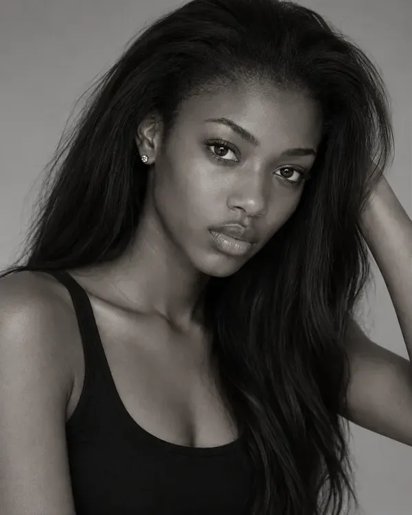 Three black and white portraits of a model with long dark hair in a black top