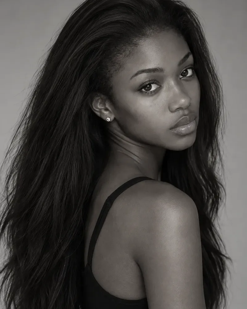 Three black and white portraits of a model with long dark hair in a black top